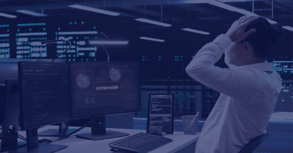 IT security professional in data center with monitors showing system hack alert, overlaid with purple filter suggesting cybersecurity crisis