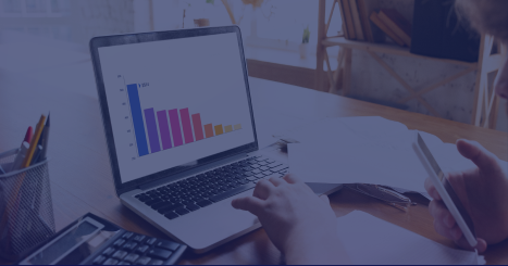 Business analytics workspace with laptop displaying bar chart data visualization, overlaid with purple filter