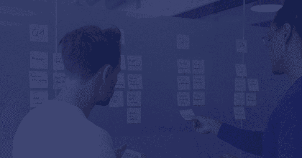 Person organizing sticky notes or cards on wall for project planning, with purple overlay filter