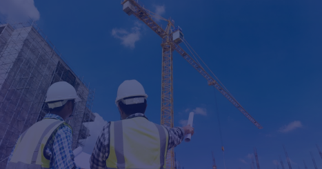 Two engineers wearing helmets and safety vests review construction plans at a site with a crane, featuring engineers at a construction site symbolizing the integration of AI and real-world industry work