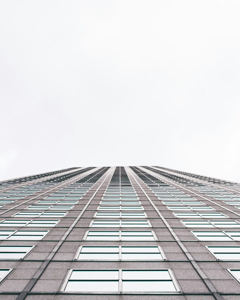 Worms-eye view looking up at modern glass office towers