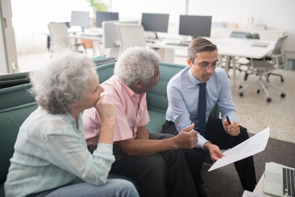 Adviser talking through paperwork with clients