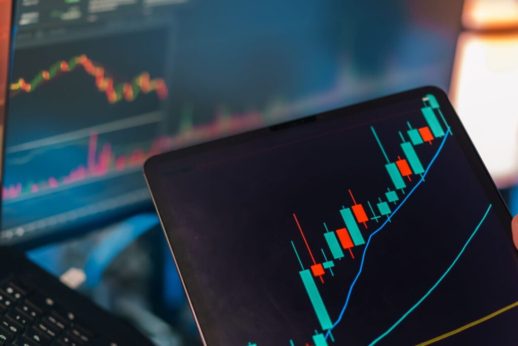 Candlestick market chart displayed on a laptop screen