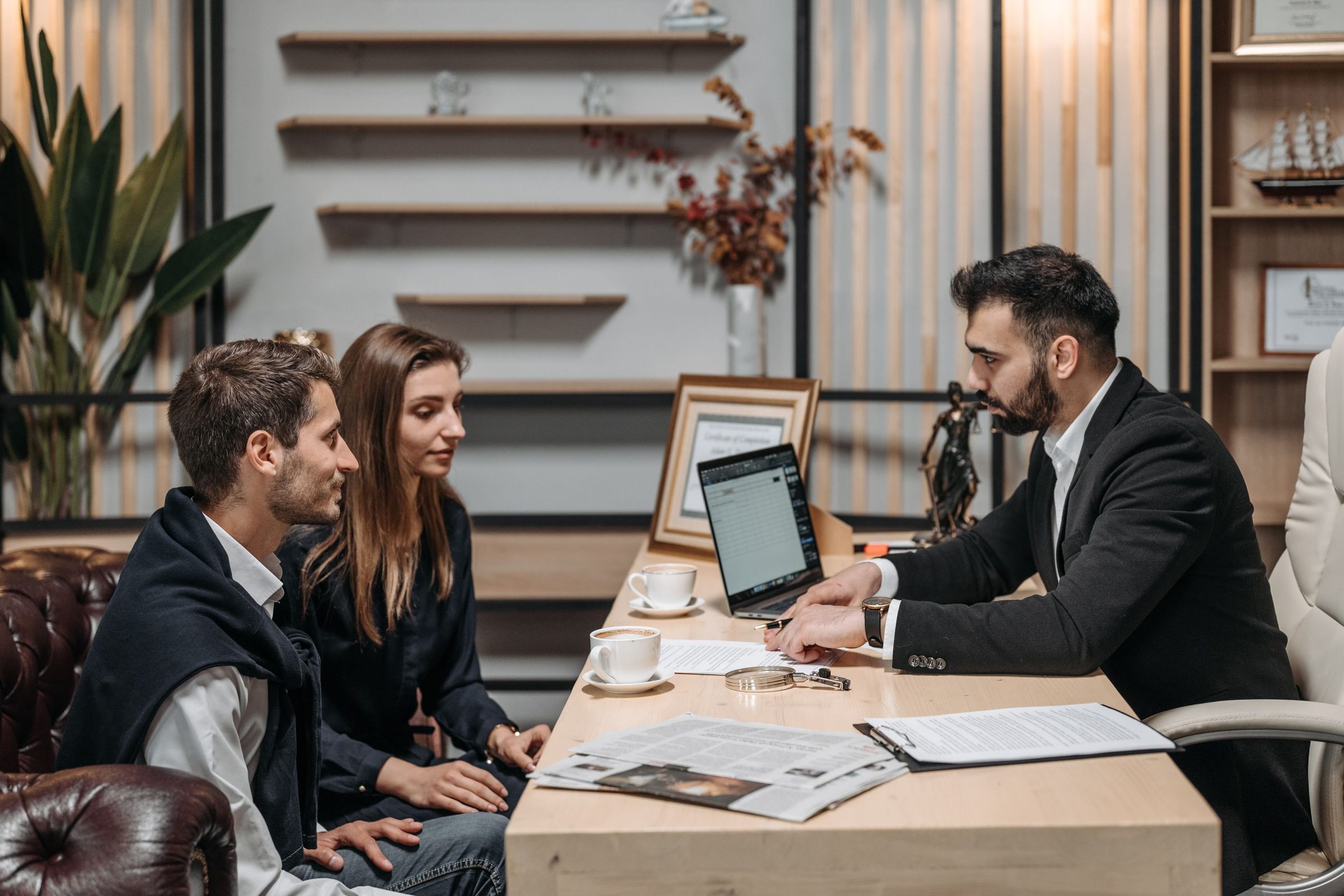 Team reviewing work together on a laptop in an office
