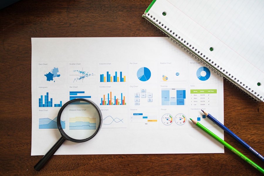 Printed charts and a magnifying glass on a desk