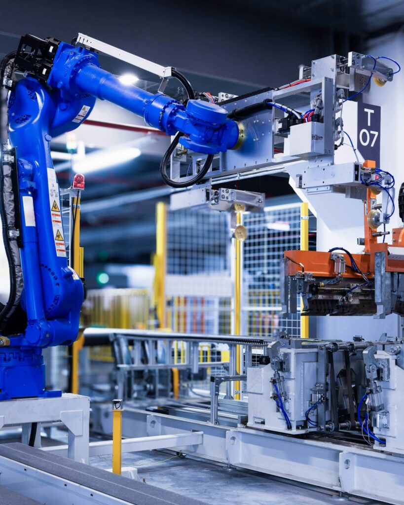 Blue industrial robot arm on a modern factory production line