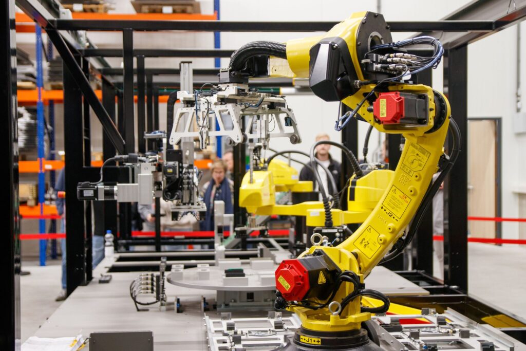 Yellow industrial robot arm on a factory production line