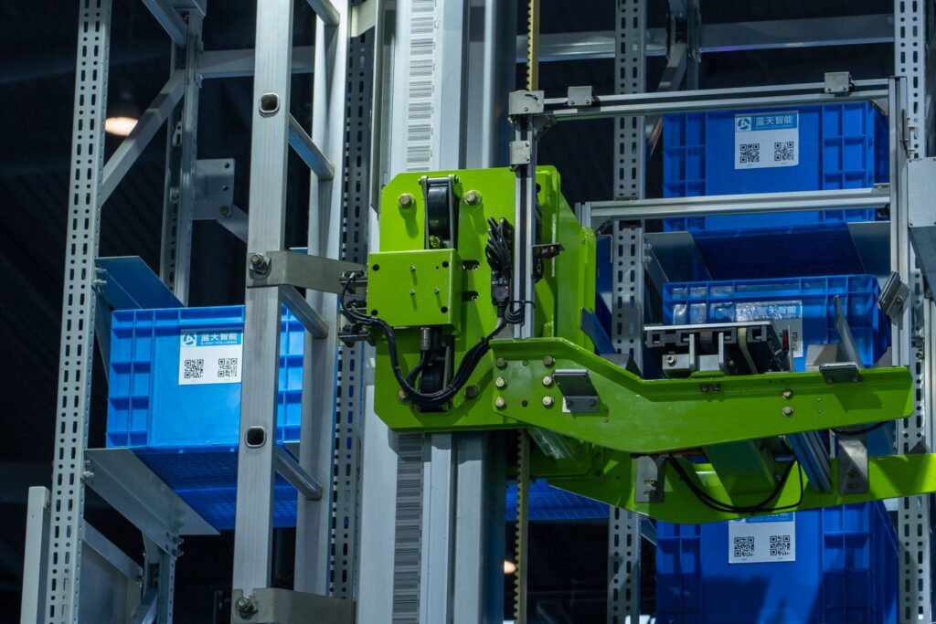 Automated storage and retrieval robot moving stock totes on warehouse racking