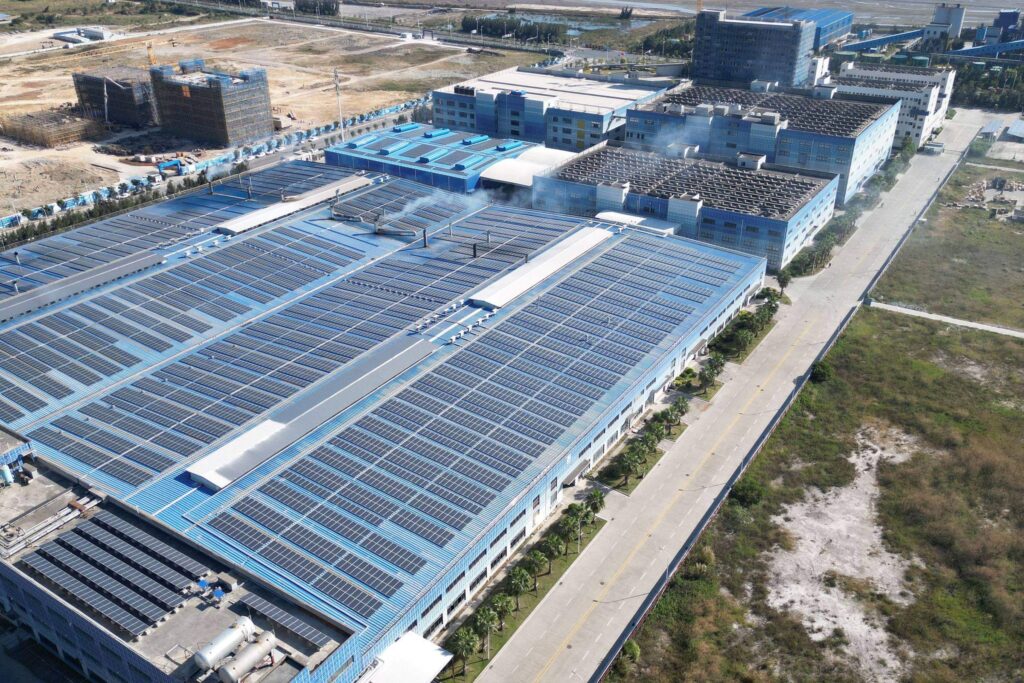Aerial view of solar panels covering the roofs of a distribution facility